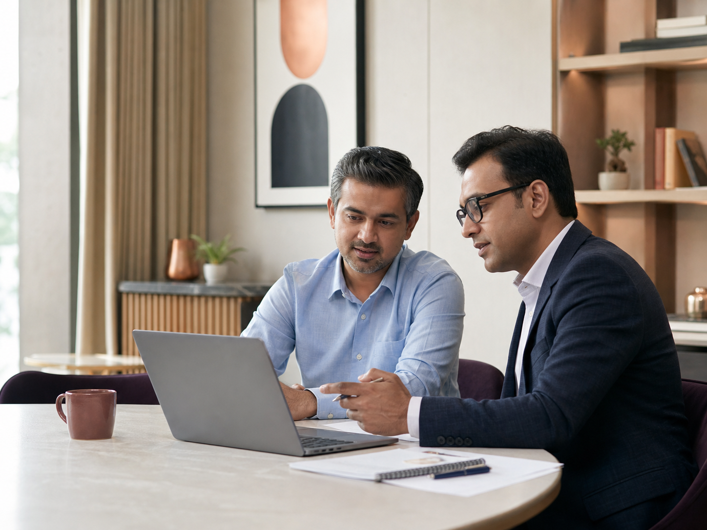 An Indian professional reviewing his portfolio with a financial planner
